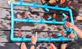 a photography of a group of people playing a game of pipe pipes, several people are playing a game of pipe pipes on a wooden deck