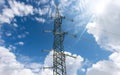 High voltage tower - Power Line Against a Blue Sky with Clouds and Sunbeams Royalty Free Stock Photo