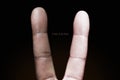 Photography idea showing a black and white finger making a peace sign against racism. Royalty Free Stock Photo