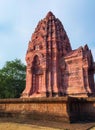 a photography of a large pink building with a clock on top, stupa bhaga temple in india with a blue sky in the background Royalty Free Stock Photo