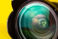 Photography lens aperture on a yellow background. Photo vision concept Royalty Free Stock Photo