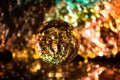 Photography lens ball on a blurred vibrant and colourful textured background with lights shining. Abstract background and backdrop Royalty Free Stock Photo