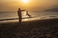 Photography of man and dog playing in the beach silhouette