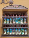 Hand painted wine bottles displayed at a window