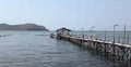 a photography of a pier with a boat and a boathouse in the background, lakeshore with a pier and a boat in the water