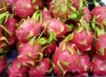 a photography of a pile of dragon fruit sitting on top of a table