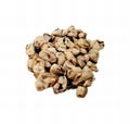 a photography of a pile of nuts on a white surface, there is a pile of nuts and other food on a white surface