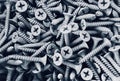 a photography of a pile of screws and bolts in black and white, a close up of a pile of screws and nails on a table