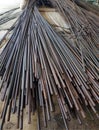 a photography of a pile of steel rods sitting on top of a table, thatched roof of a building with a bunch of sticks of wood