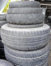 a photography of a pile of tires sitting on top of each other, spiraled tires stacked on top of each other in a pile