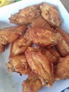 a photography of a plate of chicken wings on a table, wings on a plate with a fork and a napkin Royalty Free Stock Photo