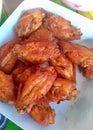 a photography of a plate of chicken wings on a table, paralithodes camtschaticas de pollitos en calzones de chicken Royalty Free Stock Photo