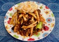 a photography of a plate of food with a fried egg on top, plate of food with a sandwich and fries on it on a table Royalty Free Stock Photo