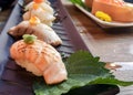 a photography of a plate of sushi with a leaf on it, plate of sushi with a variety of vegetables on it