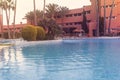 Photography of a residential area during the sunset with palms and pool