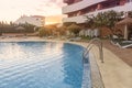 Photography of a residential area during the sunset with palms and pool