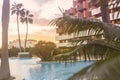 Photography of a residential area during the sunset with palms and pool