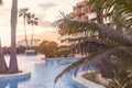 Photography of a residential area during the sunset with palms and pool