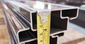 a photography of a ruler is measuring the length of a piece of metal, ruler on a metal rail with a measuring tape on it Royalty Free Stock Photo