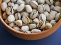 Salted pistachios in a ceramic bowl