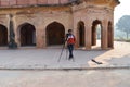 A photography student trying to take group picture of students with tripod out side of safadarjung tomb memorial at foggy winter