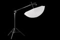Photography studio speedlight on boom with stand and umbrella isolated on black Royalty Free Stock Photo