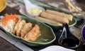 a photography of a table with a plate of food and a pair of scissors, plate of food with a spoon and a bowl of dipping sauce