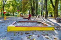 Photography on theme empty wooden sandbox with sand for kids