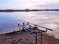 Photography of three fishing rods at lake