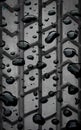 a photography of a tire with water droplets on it, sliding door with rain drops on it and a tire tread Royalty Free Stock Photo