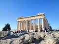 Photography of tourists visiting the majestic Parthenon temple at the top of the Acropolis hill in Athens, Greece. Royalty Free Stock Photo