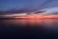 Tranquil scene at sunset  blue sky in the twilight glow over calm water surface in gloomy silence Royalty Free Stock Photo