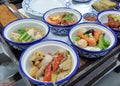 a photography of a tray with four bowls of food on it, plate of food with four bowls of food on a tray