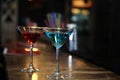 Photography of two martini glasses filled with a colored cocktails standing on the bar counter Royalty Free Stock Photo