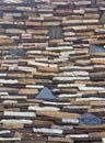 a photography of a wall made of stacked stone blocks, tile roof made of stacked stones with a blue sky in the background Royalty Free Stock Photo