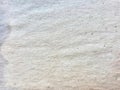 a photography of a white wall with a small hole in it, woollen texture of a white fabric with a small hole in the middle