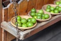 a photography of a wooden shelf with baskets of green apples, granny smith's green apples in baskets on a wooden shelf