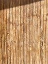 a photography of a wooden wall with a shadow of a person on it, wooden wall with a shadow of a person on it