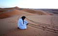 Photographying sandy footprints and tyre tracks Royalty Free Stock Photo