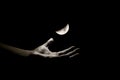 A photohraph of a hand trying to hold moon