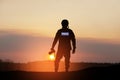 Photojournalist silhouette documenting war or conflict. Photojournalist at sunset.