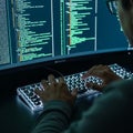 Photorealistic close-up shows a programmer\'s hands working on a high-tech transparent keyboard, interacting with glowing green co Royalty Free Stock Photo