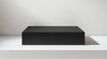 A photorealistic image of a large rectangular black box with a matte finish and sharp edges Royalty Free Stock Photo