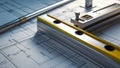Photorealistic image of a level tool next to a blueprint Royalty Free Stock Photo
