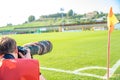 Photoreporter with telephoto lens on a football match Royalty Free Stock Photo