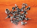 Photos bolts, nuts, screws on the wooden background Royalty Free Stock Photo