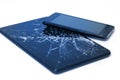 Photos of cracked display on a tablet and black cellphone isolated on white. Tablet with damaged screen