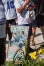 Photos, drawings, posters with a portrait of Diego Maradona in the hands of fans on the day of farewell to the idol Royalty Free Stock Photo