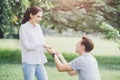 Photos of engagements, marriage proposals, and newly engaged couples lover young man and lady outdoor green park Royalty Free Stock Photo