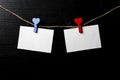 Photos are held with heart-shaped clothespins on a rope. Copspace. Valentine`s Day